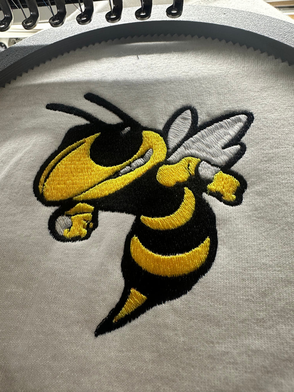 Hornet embroidery held in an embroidery hoop